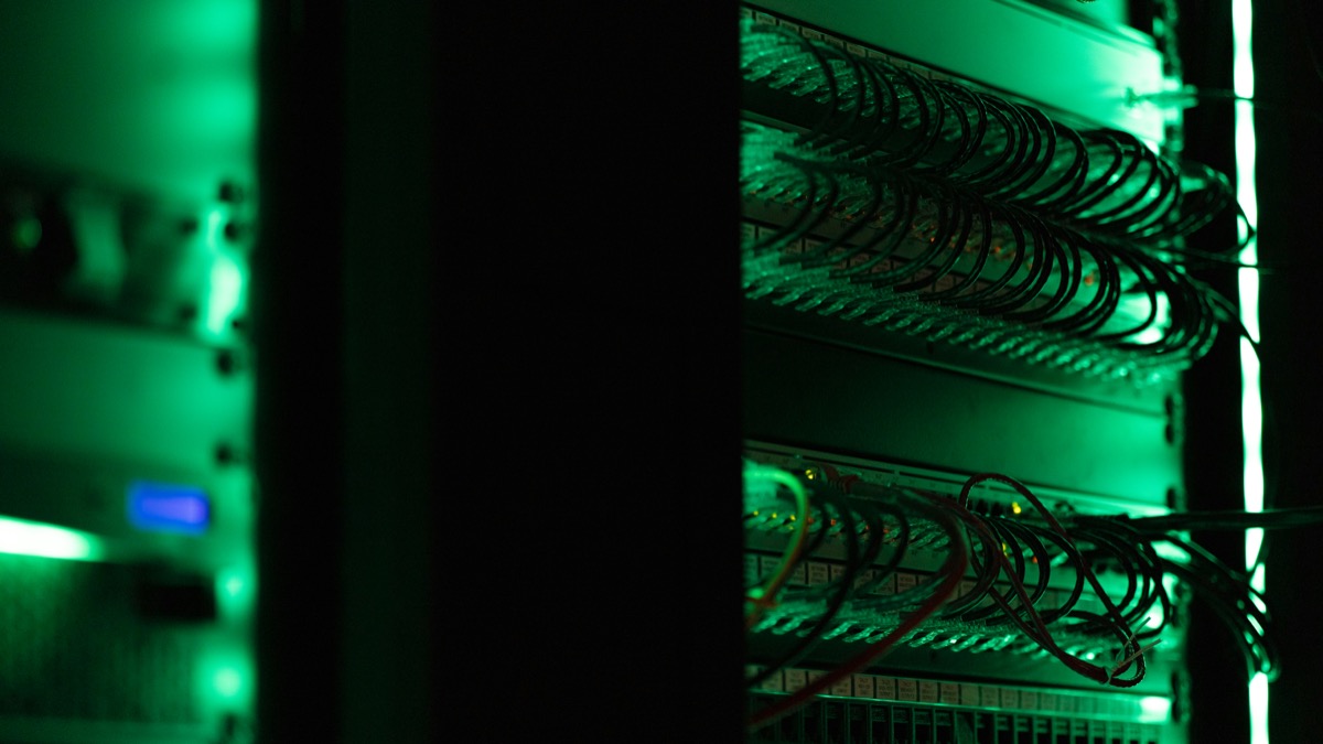 Server rack with network equipment in a dark room