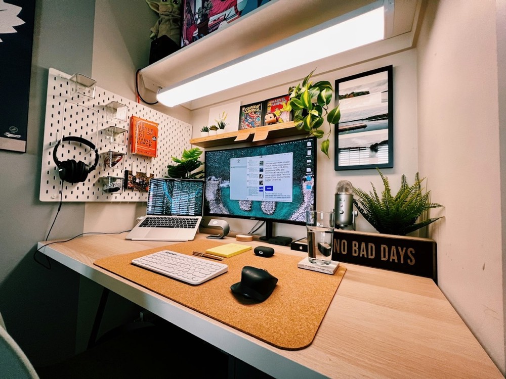 Organized home office workstation with multiple devices and accessories